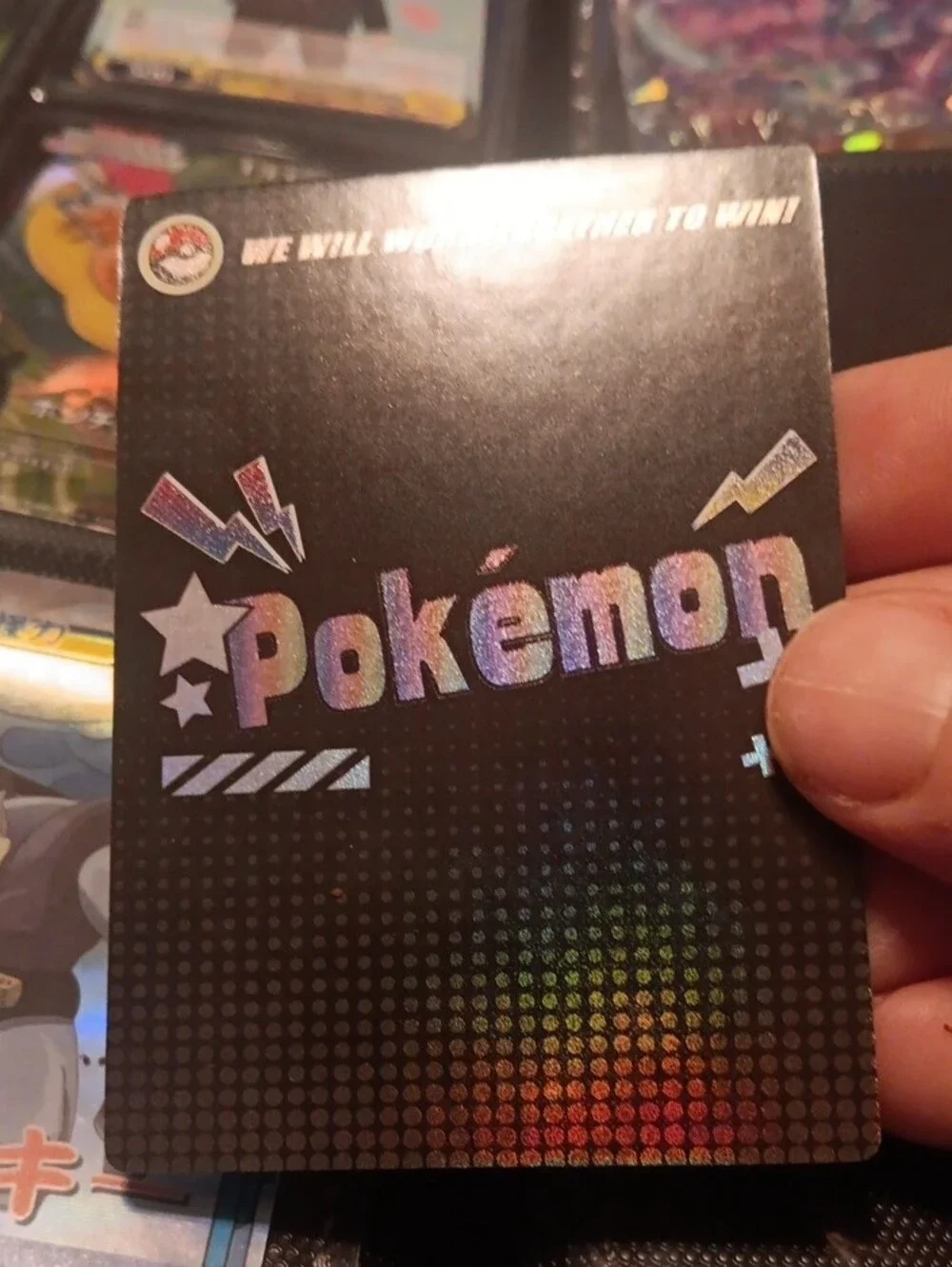 Pokemon Holographic Card with Blue Purple and Brown Characters